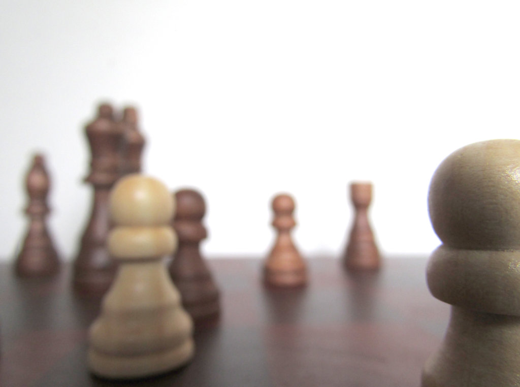Wooden chess pieces with one in focus