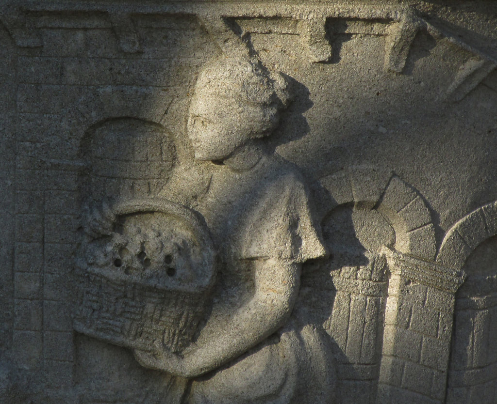 A picture showing the side of a large planted with images engraved