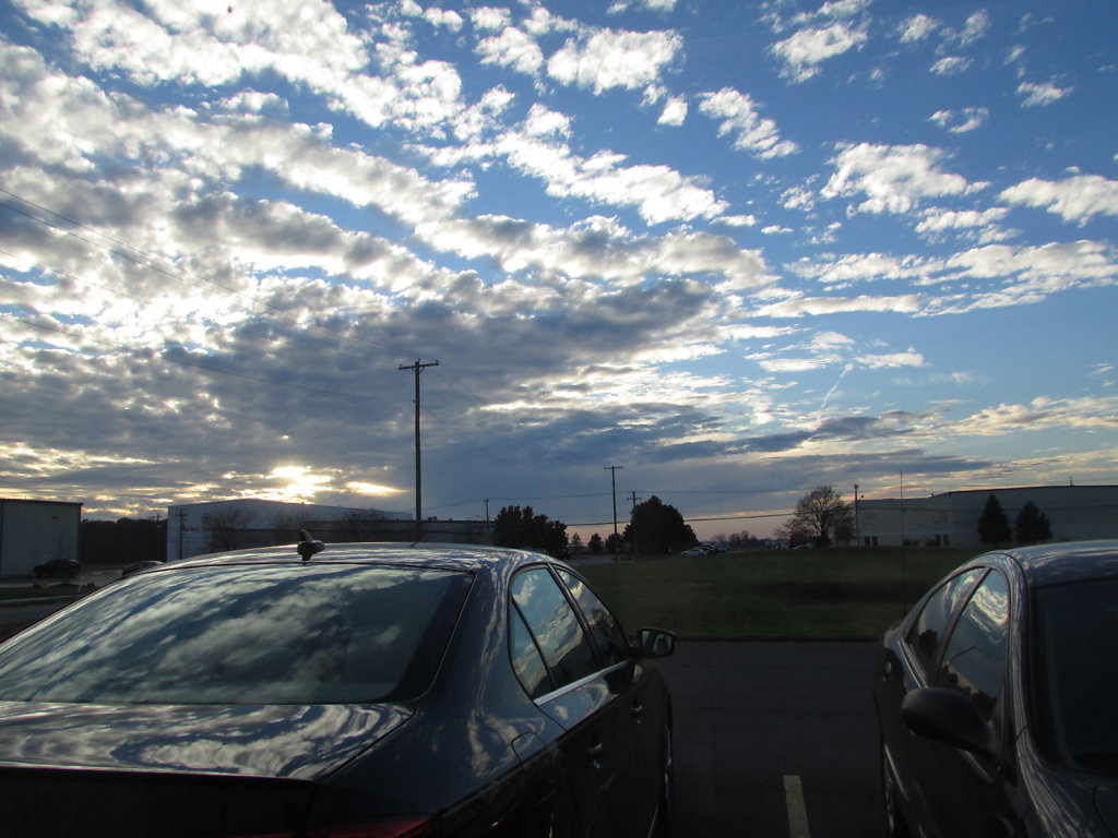 Beautiful sun set with clouds over a parking lot