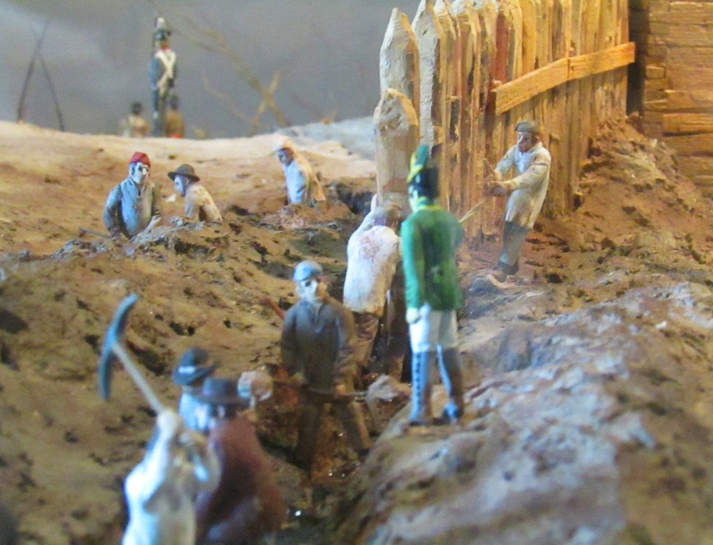Toy figures reenact the building of a trench