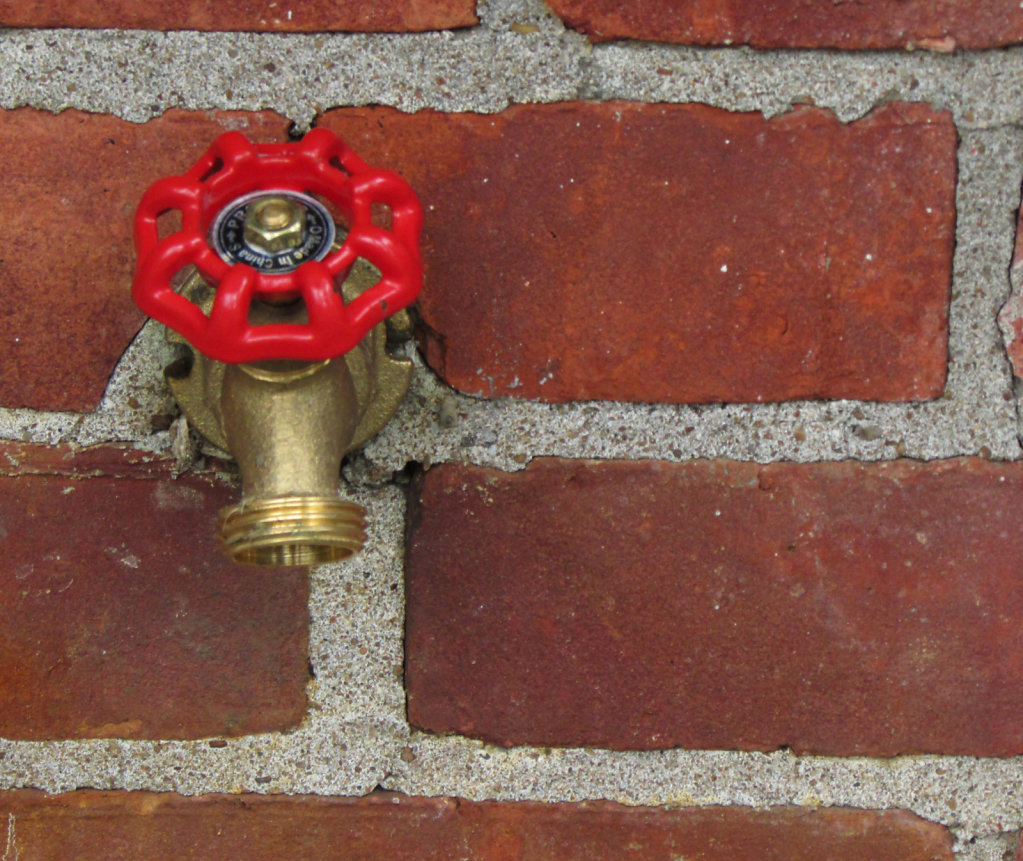 Faucet in brick wall image