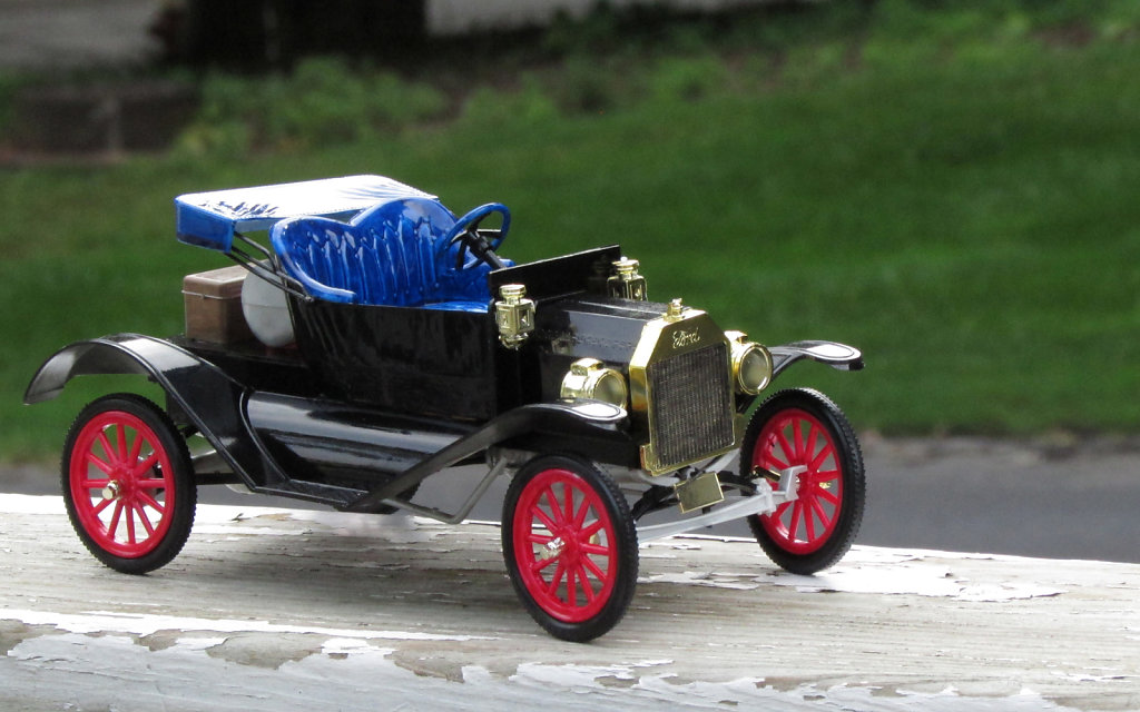 Small toy car model with red spokes 